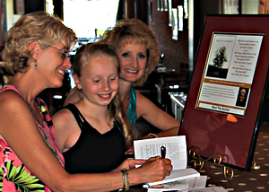 Signing her book, Tree Spirited Woman